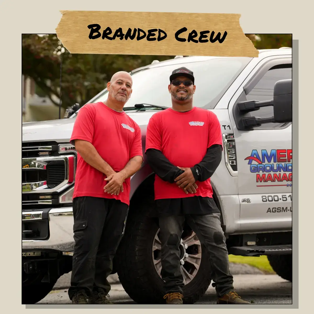 American Ground & Snow crew in matching red shirts beside a branded truck