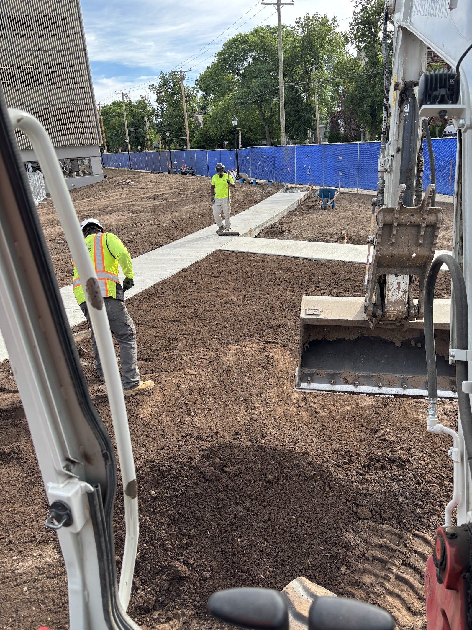 Gregory Construction crew grading a commercial site, seen from the excavator cab
